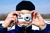 Man with compact camera in winter