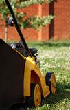 yellow lawn mower on green grass