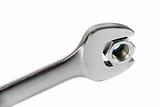 The image of a wrench with a nut, isolated, on a white background