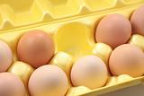 Eggs in yellow packing box.