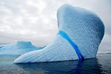 huge white iceberg with blue streak