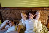 young couple sleeping in bed