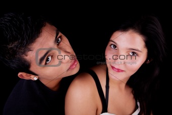 a beauty and cute couple looking up, isolated on black, studio shot