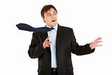 Shocked  young businessman with blowing tie
