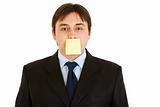 Young businessman with blank  sticky note on his forehead
