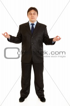 Meditating modern businessman isolated on white background
