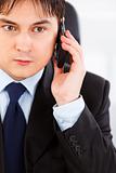 Concentrated businessman talking on mobile phone
