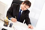 Successful businessman signing important  contract in office
