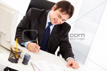 Successful businessman signing important  contract in office
