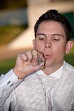 well dressed groom blowing bubbles through a wedding ring
