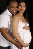 Sexy beautiful pregnant Indian woman and african male embracing
