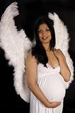 beautiful pregnant woman in white dress and angel wings