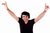 man listening music in headphones, arms raised, isolated on white background, studio shot