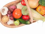 Raw vegetables in basket isolated on white