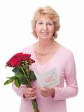 Elderly woman with red roses and card