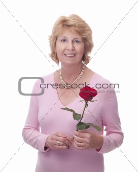 Senior woman holding a single red rose