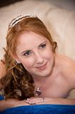 just married bride laying down with cleavage visible whilst smiling