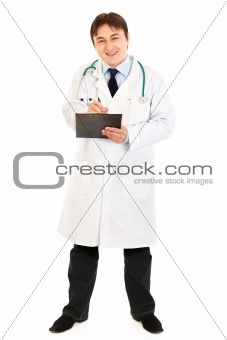 Smiling doctor  with stethoscope making notes in medical chart
