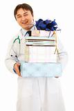 Smiling medical doctor holding gifts in hands 
