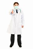 Medical doctor wearing mask and showing  thumbs up gesture
