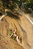 Girl in swimsuit on waterfall