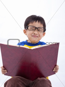 Happy young asian boy with book