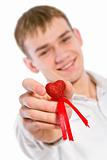 Young man holding heart in his hand.
