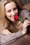 Attractive young girl with a red rose