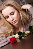 Attractive young lady with a red rose