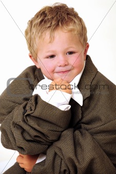 Boy in oversized business clothes in thinking position