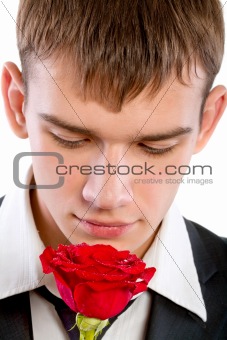 man smelling a rose