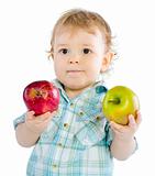 Beautiful baby boy play with green and red apples.