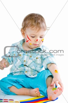 Beautiful baby covered in bright paint
