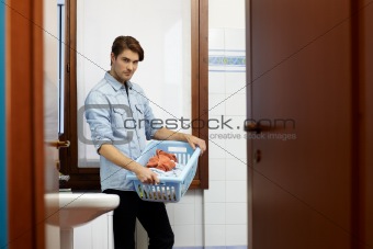 man doing chores with washing machine