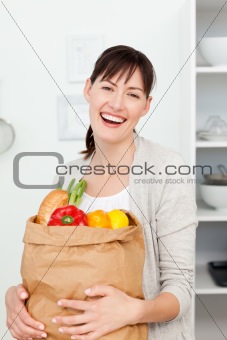 Woman with shoping bags in the kitchen 