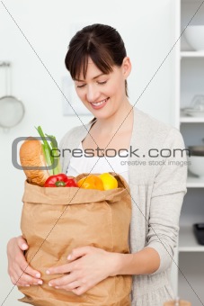 Woman with shoping bags in the kitchen 