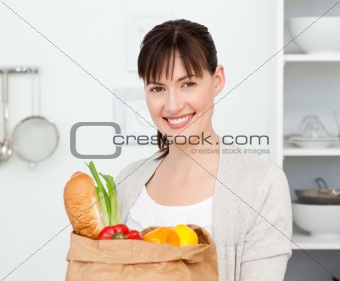 Woman with shopping bags in the kitchen