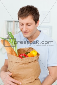 Man with shoping bags in the kitchen 