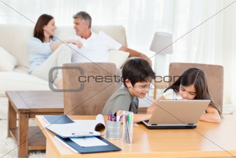 Children working on their laptop at home