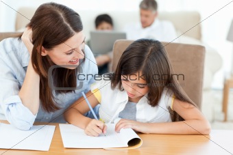 Mother helping her daughter for her homework 