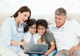 Family looking at  the laptop 