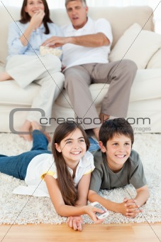 Family watching tv in the living room