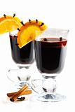 Mulled wine in glass, decorated with orange, cinnamon and clove.