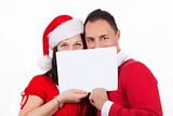 young couple in christmas clothes holding a white cardboard