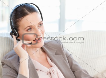 Businesswoman phoning in her living room