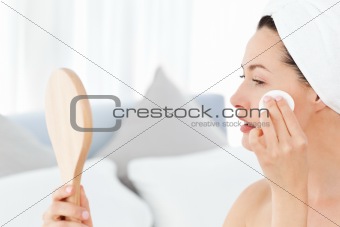 Attractive woman putting on Make up