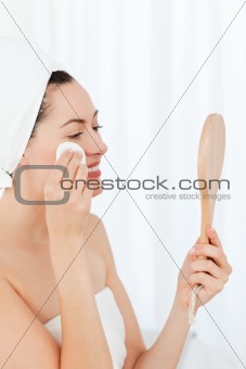 Beautiful woman putting on Make up