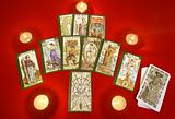 Tarot cards with candles on red textile