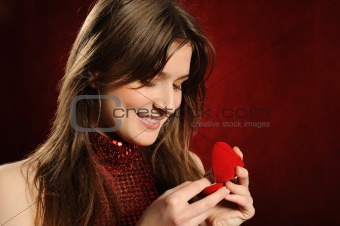 Beautiful woman with a heart gift