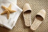 Spa slippers on seagrass carpet with towels 